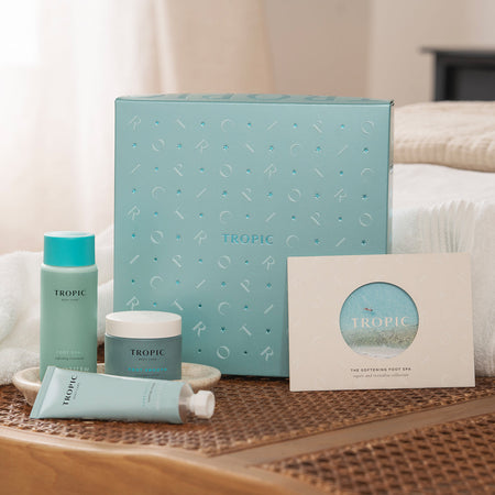 The Softening Foot Spa - repair and revitalise collection by Tropic. A light blue gift set box displayed with matching products: Foot Soak hydrating treatment, Foot Smooth intensive balm, a Repairing foot Remedy and card.